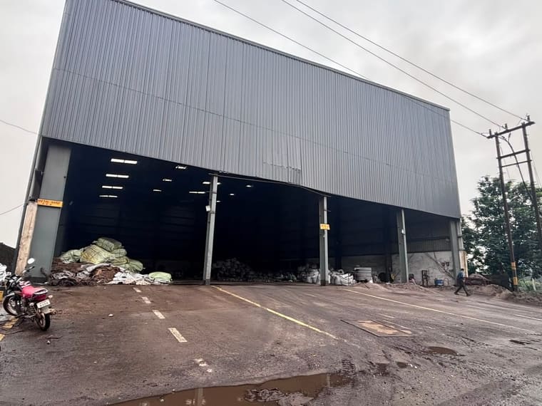 The metal yard at Sarandi: a clad shed open along one side, finished alloy bagged and stacked inside