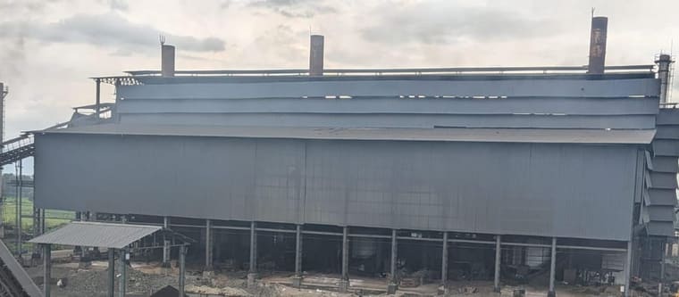 The third unit furnace building: a long clad shed on steel columns with three stacks