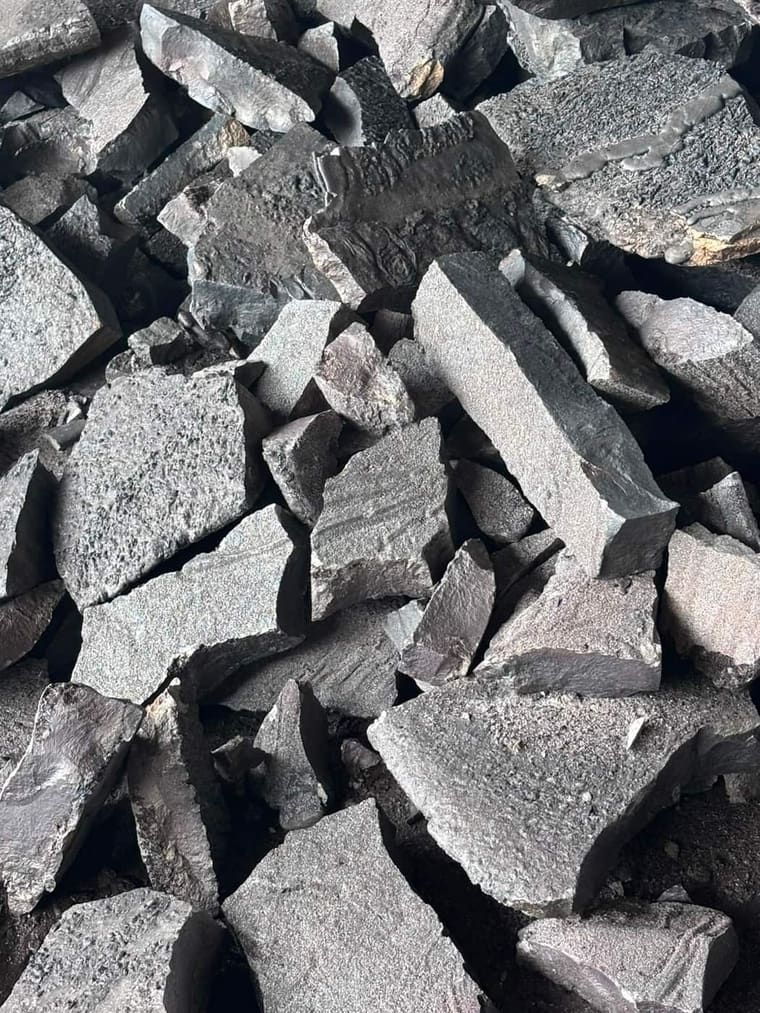 Alloy in larger pieces, matte grey fracture surfaces