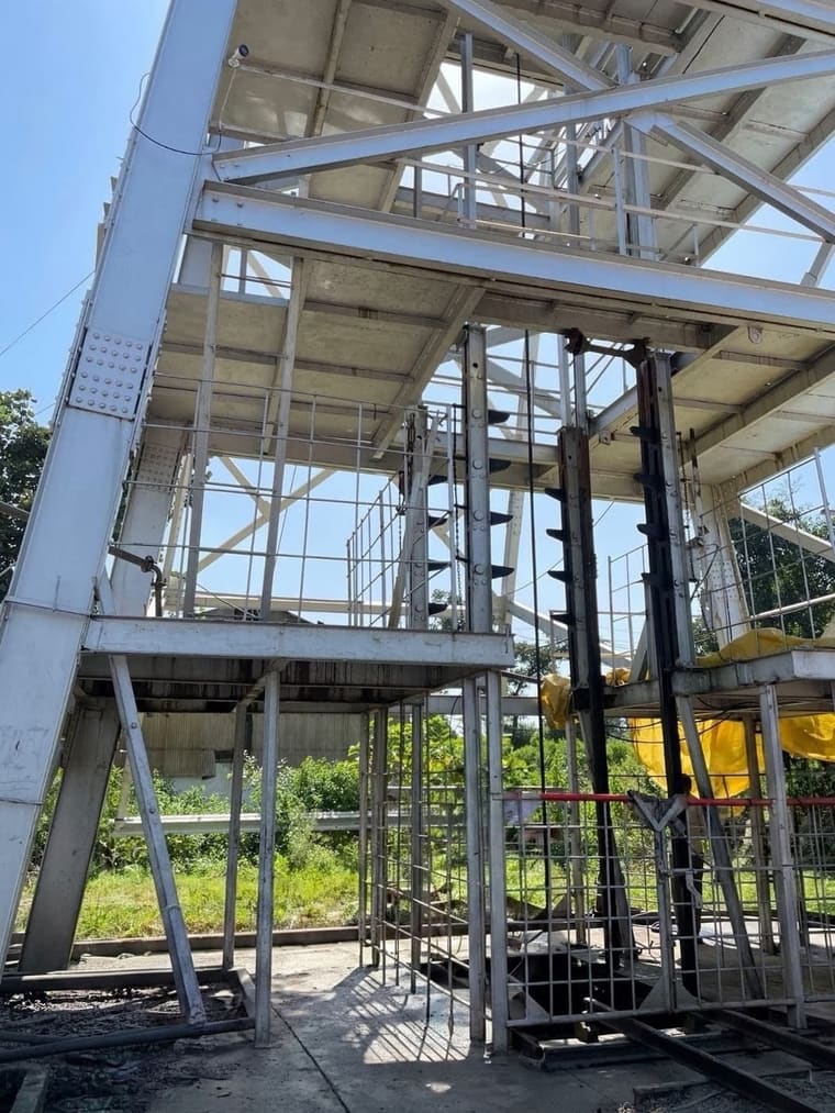 White structural steelwork over R shaft at the Ramrama mine, carrying the vertical conveyor and elevator casings
